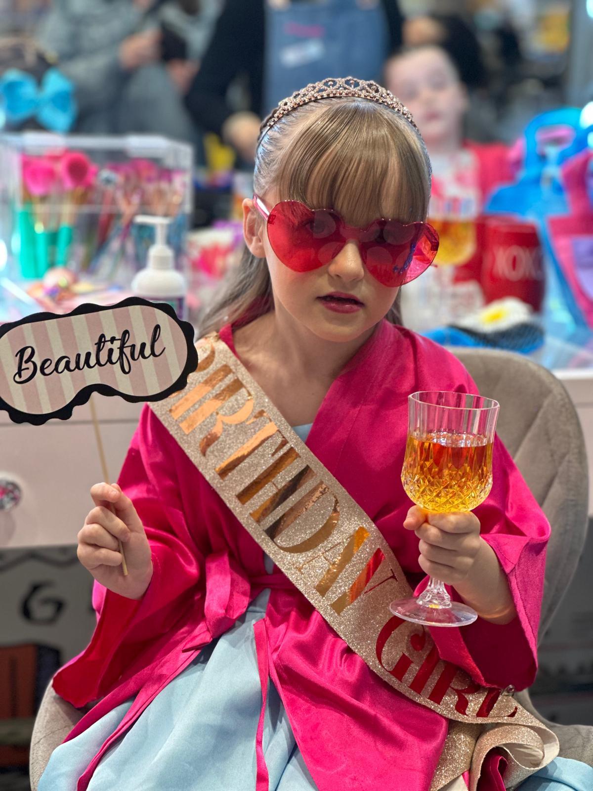 Birthday girl in a sash at a StarKids party